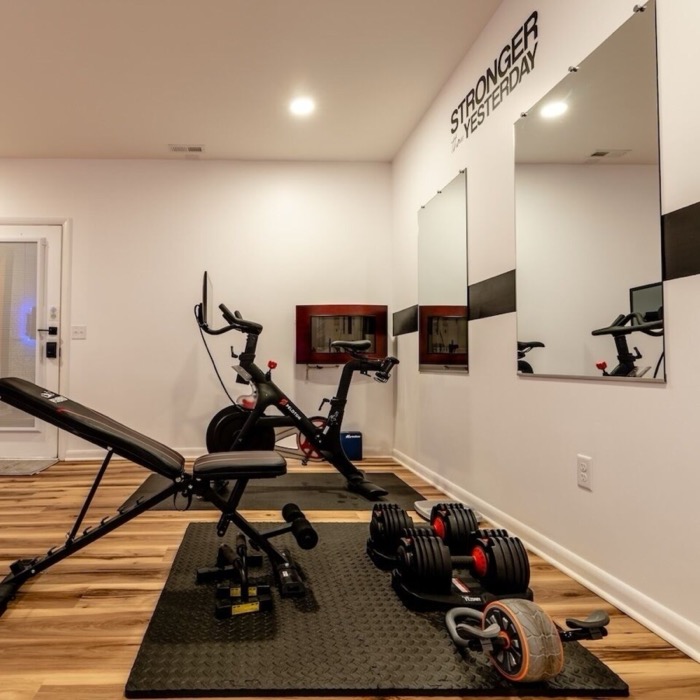 Home gym with bike, bench and dumbbells at Cedar Escape