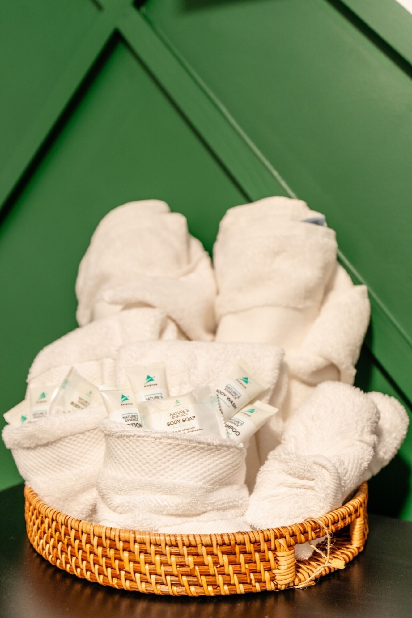 Rolled towels and toiletries provided for guests