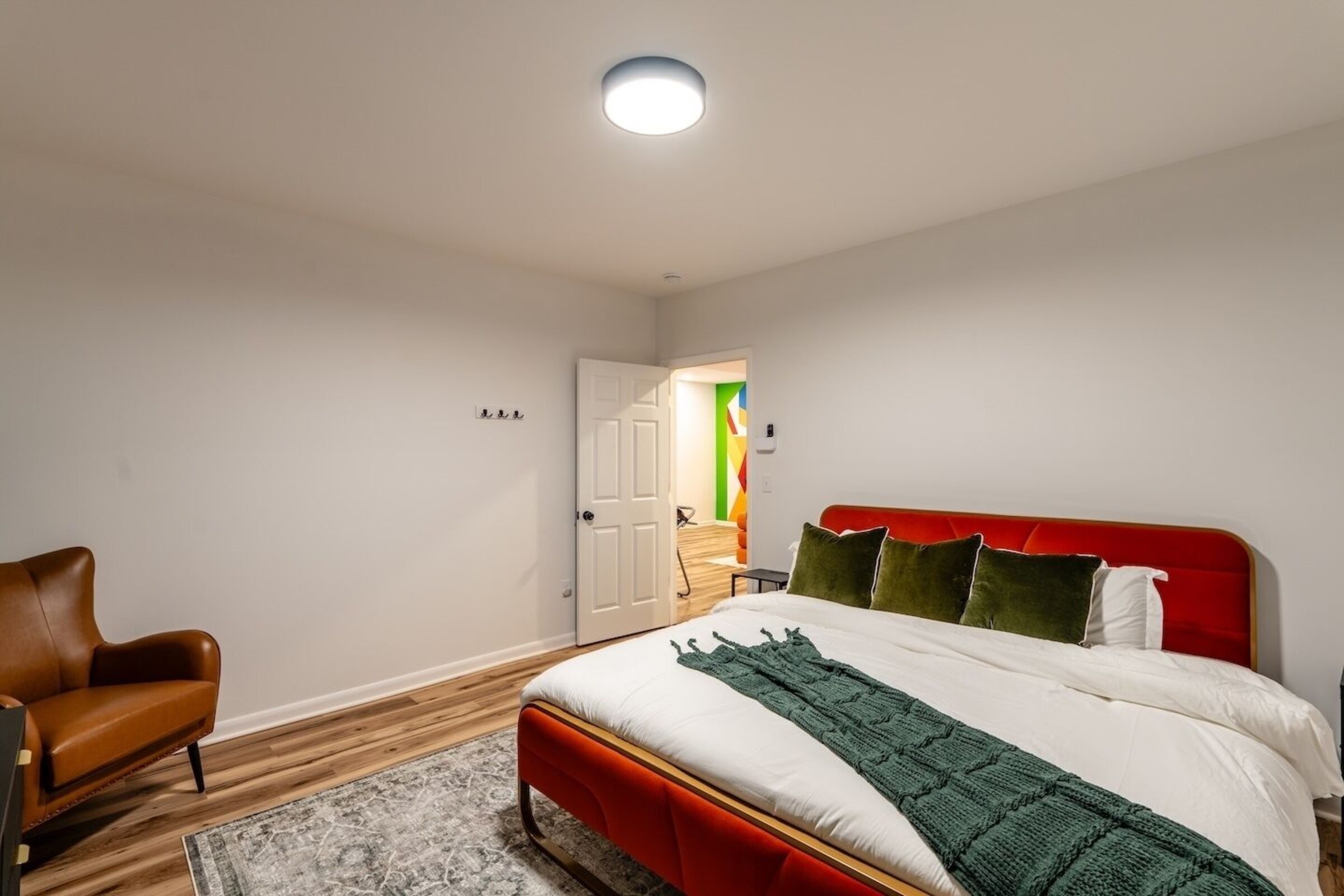 Basement guest bedroom with wood accent wall